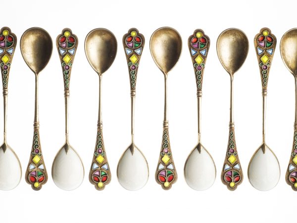 12 golden spoons lined up in a row