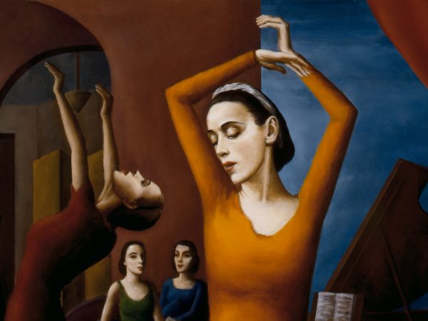 Interior view of dance studio; in center foreground, woman in yellow/orange dress with arms above head; 4 other female dancers to left & behind her; piano at right