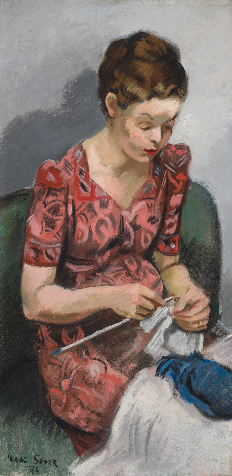 A pregnant girl sitting on a sofa, knitting a blue and white sweater.