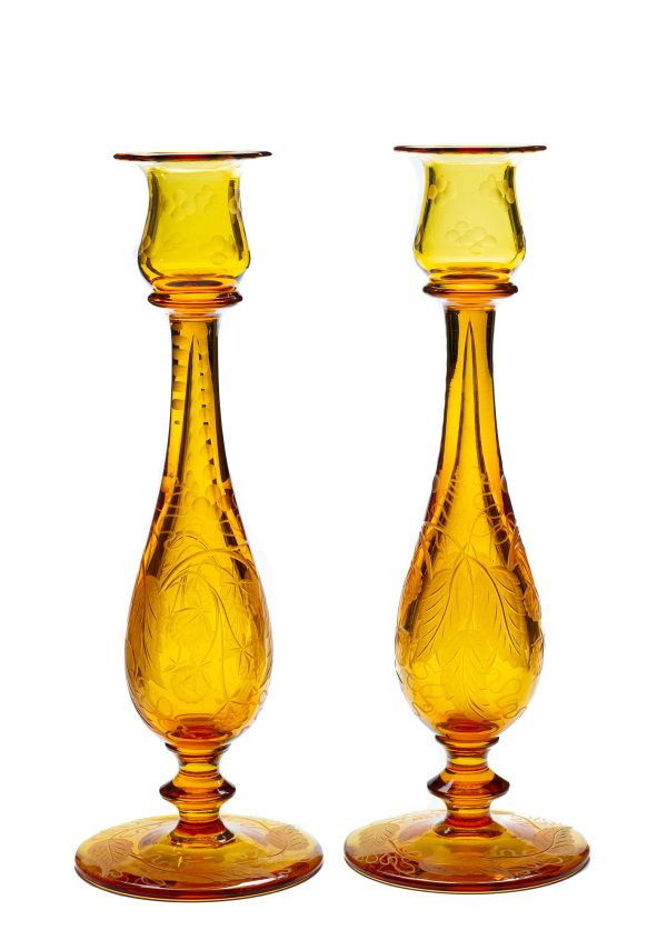 A pair of amber candlesticks in the blackberry pattern