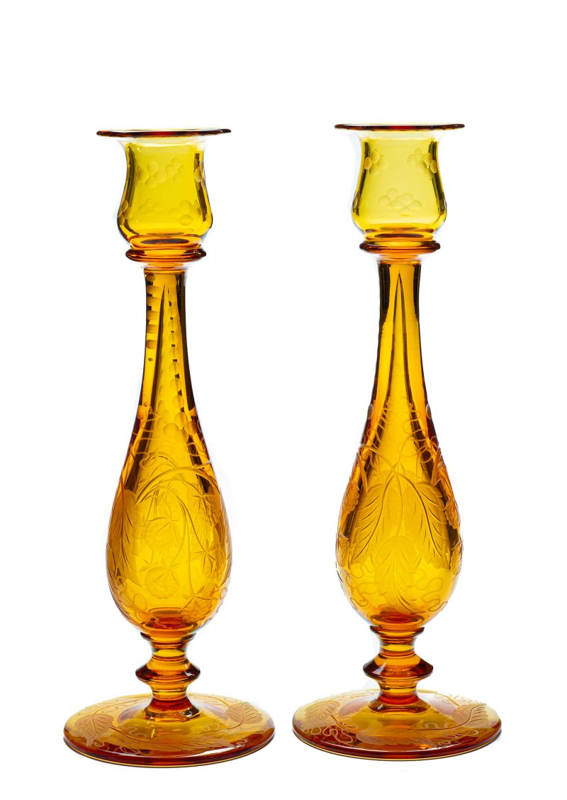 A pair of amber candlesticks in the blackberry pattern