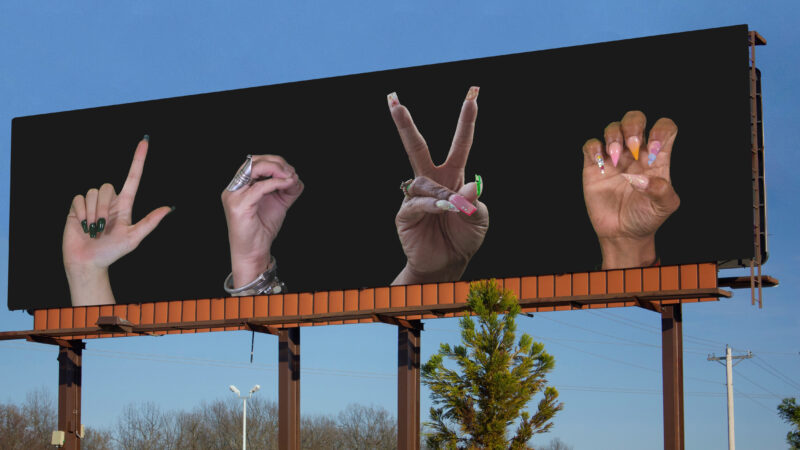Billboard with hands showing the word Love in sign language