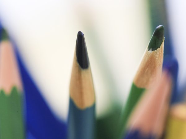 Photo of several colored pencils with tips up