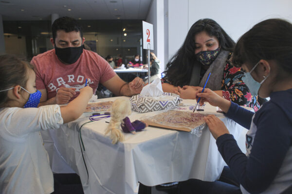 Family doing artmaking activities at a table