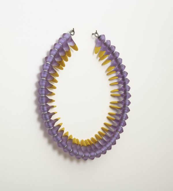 Circular glass artwork in light purple and yellow colors