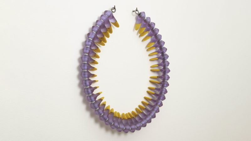 Circular glass artwork in light purple and yellow colors