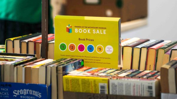 Boxes of books with a price chart in the middle of the photo