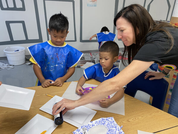 Museum Education Coordinator Airion Rivero (far right) assists with artmaking during Family ArtVenture, a free, Saturday event for families