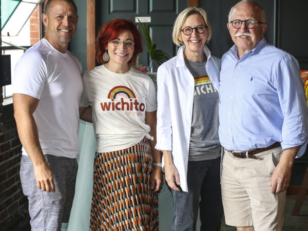 Four people, dressed casually in shorts.