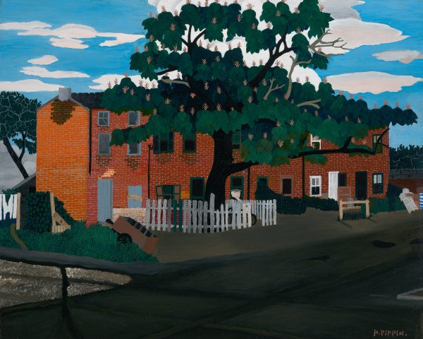 A red brick building with a large tree in the front. A man is by the tree, behind the picket fence.
