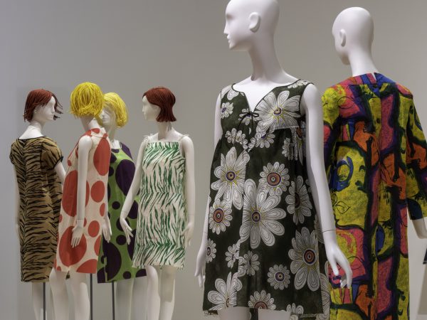 Image of the galleries at the Phoenix Art Museum that show several colorful paper dresses on view