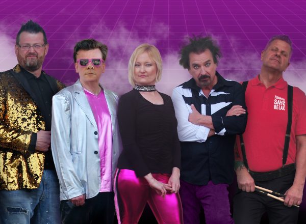 Band portrait of four men with a woman in the center, all dressed in colorful, 80s-inspired outfits