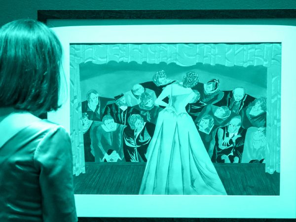 Monochrome image in blue of a girl with shoulder-length brown hair looking at a painting