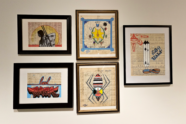 Paintings of Native American images on ledger paper.